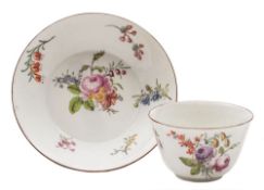A Chelsea teabowl and saucer: painted with floral sprays and sprigs,