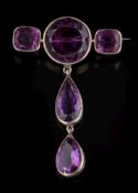 An amethyst mounted brooch: with a bar of one circular and two cushion-shaped stones,
