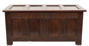 An early 18th Century oak rectangular coffer:, of moulded panel construction, having a hinged top,