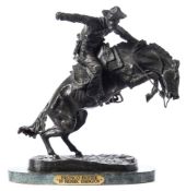 After Frederic Remington Bronco Buster:, a patinated bronze study of a bronco rider,
