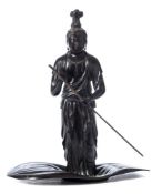 A Japanese bronze figure of Kwannon: standing in a lotus leaf boat with a paddle in her hand,