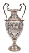 An Indo-Persian silver vase: of ovoid outline with scrolling handles to the sides,