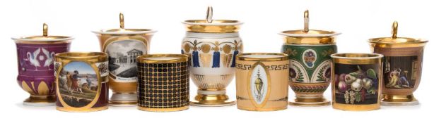 A group of four early 19th century Paris porcelain coffee cans and five cups: the cups in Empire
