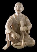 A Japanese carved ivory okimono: of a peasant farmer sharpening his scythe, unsigned, Meiji period,