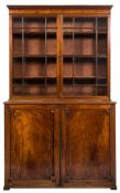 An early 19th Century mahogany bookcase:, the upper part with a moulded cornice,