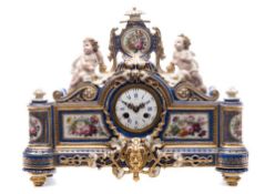 A Paris porcelain figural mantel clock: the cartouche shaped case with central mask flanked by