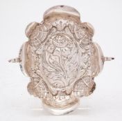 A Continental silver dish: of oval lobed form with embossed floral decoration and two scroll