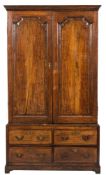 An 18th Century oak and crossbanded hall cupboard:, in two sections,