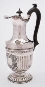 An Edward VII silver hot water jug, maker William Aitken, Birmingham, 1903: with domed hinged lid,