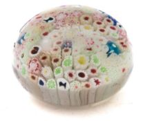 A George Bacchus close pack glass paperweight: set with various multi coloured canes and four