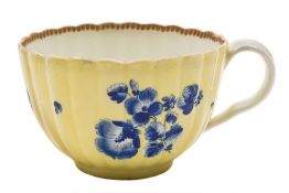 A First Period Worcester tea cup: of reeded form with ear-shaped handle,