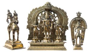 A Burmese brass shrine figure group: the domed and pierced backplate mounted on a rectangular stand