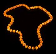 An amber bead single string necklace: with irregular beads between and bolt ring clasp,