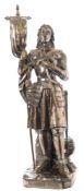 A silver plated model of Joan of Arc: wearing full armour and holding a standard in her right hand