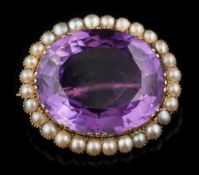 An amethyst and seed pearl oval brooch: with central oval amethyst,
