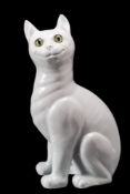 A Galle-style pottery cat: in the white, modelled in seated posture with inset glass eyes,