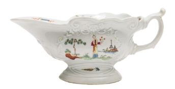 An early Worcester sauceboat: of high-footed form moulded with C scrolls and foliate cartouches,