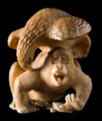 A Japanese carved ivory okimono: of an eagle attacking a howler monkey, unsigned, Meiji period, 4cm.