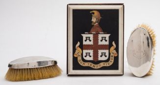 An inlaid marble plaque: bearing the crest of the Wrey family, on a wood stand,20 x 15.5cm.