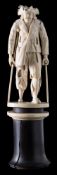 A 19th century German carved ivory figure of a beggar: wearing a bicorn hat, patch over one eye,