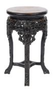 A Chinese carved hardwood circular jardiniere stand: with a pierced prunus decorated apron on