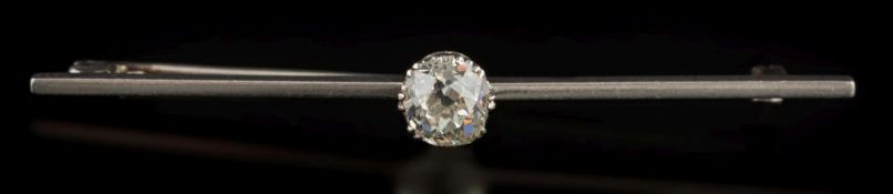 A diamond solitaire bar brooch: the round old, brilliant-cut diamond estimated to weigh 0.