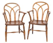 Two similar early 19th Century elm, ash, fruitwood and beech hoop back Windsor elbow chairs:,