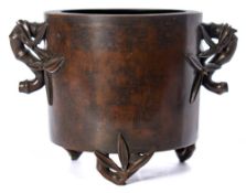 A Chinese inlaid bronze tripod incense burner: of cylindrical form with imitation bamboo handles