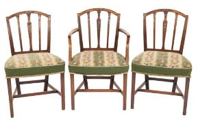 A set of eight George III mahogany dining chairs in the Hepplewhite taste:,