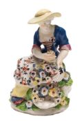 A Bow figure of a girl flower seller: holding flowers in the folds of her skirt and in a basket,