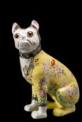 A Galle-style pottery pug: modelled seated and transfer decorated with flowers on a yellow ground,