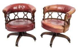 A set of six 1920's/30's stained mahogany revolving tub-shaped office armchairs:,