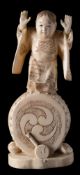 A Japanese carved ivory okimono of a child standing on a drum: wearing traditional robes,