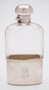 A George VI clear glass and silver mounted hip flask, maker Mappin & Webb, London, 1912: initialled,