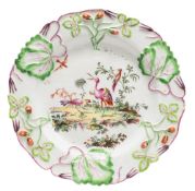 A Longton Hall strawberry plate: the rim moulded in relief with leaves, tendrils and strawberries,