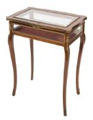 A mahogany and gilt metal and brass mounted bijouterie display table in the French taste:,