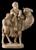 A late 19th century Indian carved sectional ivory figure: of a merchant riding on the back of a