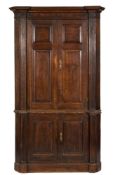 An 18th Century oak and mahogany Architectural standing corner cupboard:, in two parts,