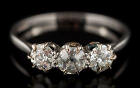 A graduated diamond three-stone ring: with round old-cut diamonds estimated to weigh a total of 1.