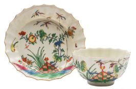 A First Period Worcester tea bowl and saucer: of faceted form,