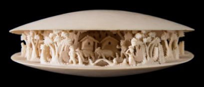 An early 20th century Japanese carved ivory okimono of the clam's dream: partially open to reveal a