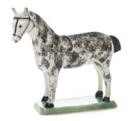 An English creamware model of a horse: with sponged grey markings,