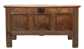 An early 18th Century oak rectangular coffer:, with a plain hinged moulded top,