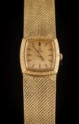 Omega. A lady's 18ct gold 'Omega' wristwatch:, the textured gold colour, rectangular dial 17.