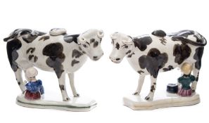 A close pair of North Country pottery cow and milkmaid creamers: modelled standing four square with
