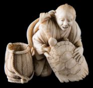 A Japanese carved ivory okimono: of a fisherman handling a turtle, with a basket by his side,