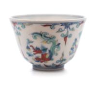 A small Chinese Doucai cup: painted with four dragon medallions between sprays of scrolling foliage,
