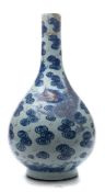 A Chinese underglaze blue and copper-red bottle vase: boldly painted with two large dragons amongst