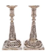 A pair of Austro-Hungarian silver candlesticks: the cylindrical nozzles with flared sconces each on