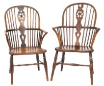 An early 19th Century elm, ash and beechwood wheel and stick back Windsor elbow chair:,
